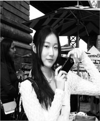Kelly Hong holding a small camera.